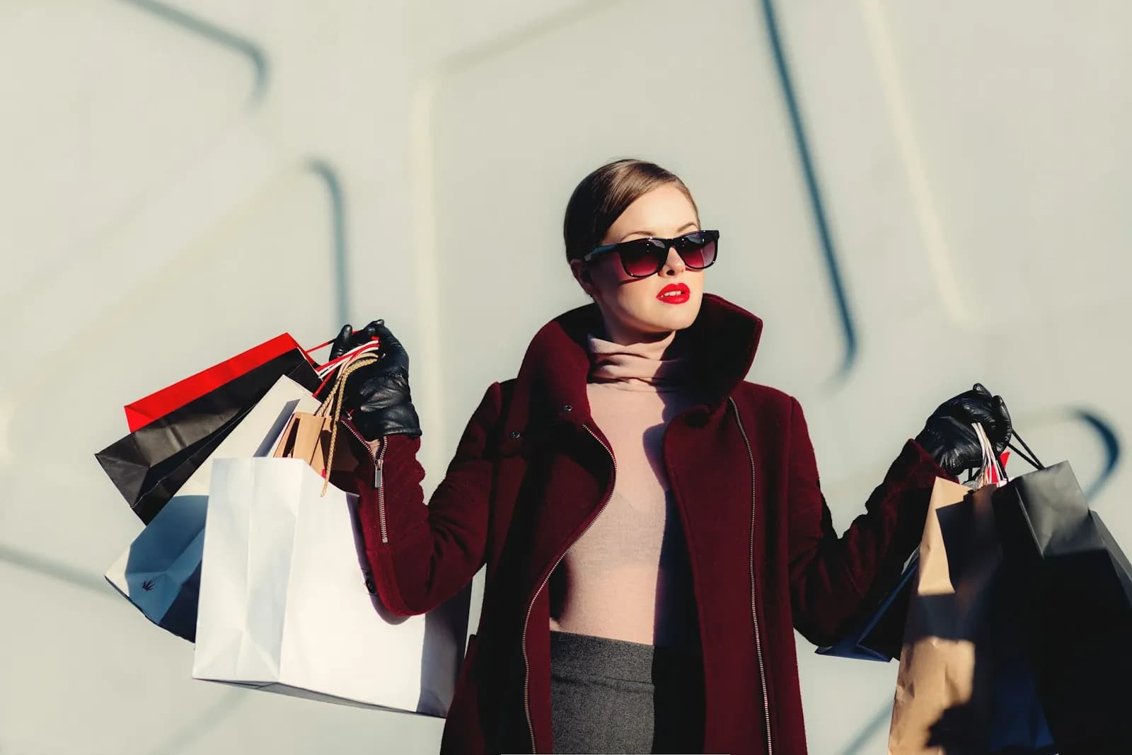 A shopper smiling at her phone, card in hand